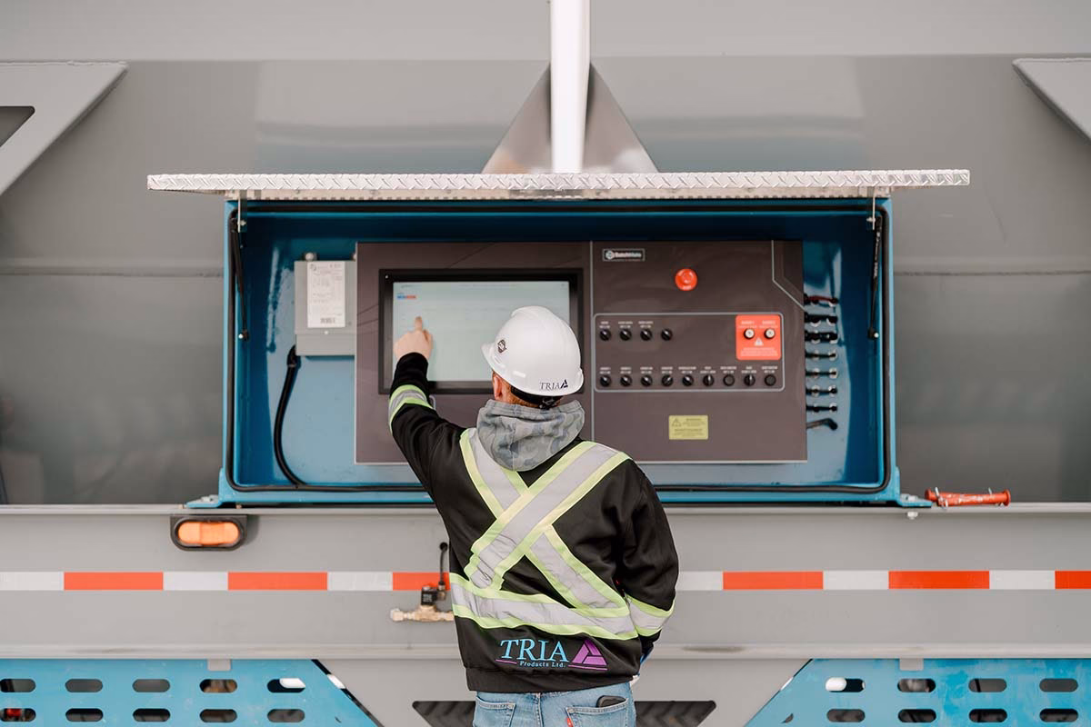 Man operating concrete batch plant using BatchMate